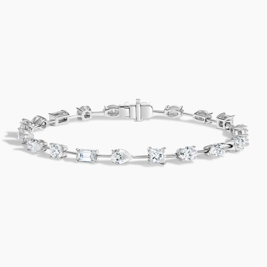 White gold tennis bracelet with assorted lab-grown diamond cuts on white background