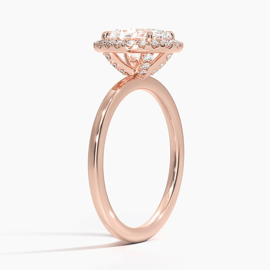 Rose gold oval halo engagement ring with lab-grown diamonds on white background