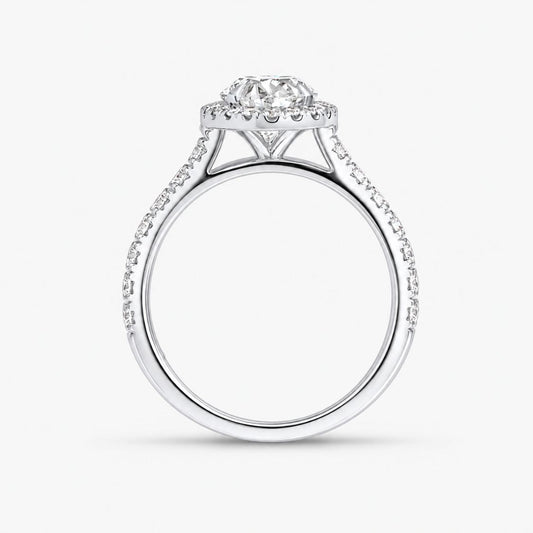 A silver diamond engagement ring with a round-cut center stone and a halo of smaller diamonds, set against a plain white background.