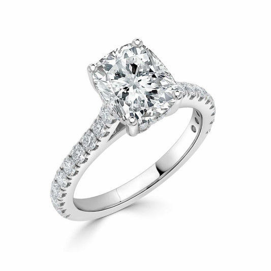 A radiant cut diamond engagement ring in a polished white gold or platinum setting, featuring a halo of small pavé diamonds along the shank, shown on a clean white background.
