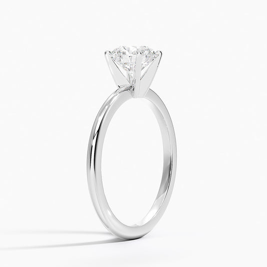 White gold solitaire engagement ring with round lab-grown diamond in four-prong setting