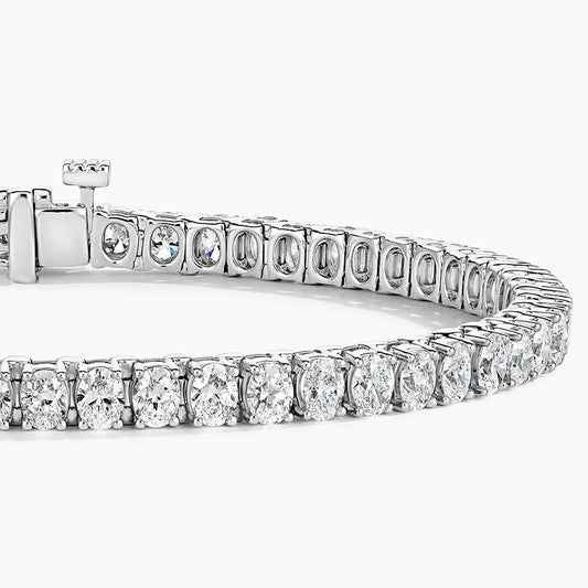 Oval cut lab-grown diamond tennis bracelet in white gold on white background