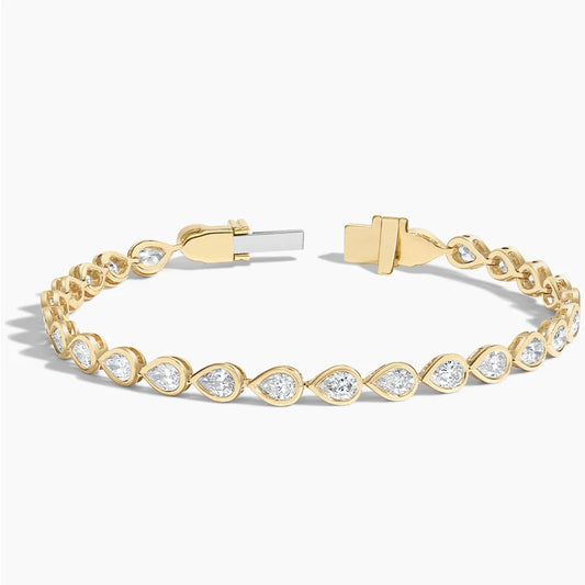 Yellow gold tennis bracelet with pear-shaped lab-grown diamonds on a white background
