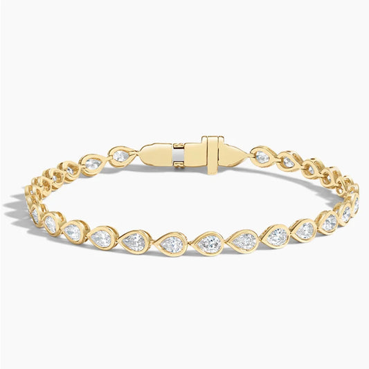 Gold tennis bracelet with pear-shaped lab-grown diamonds on a white background
