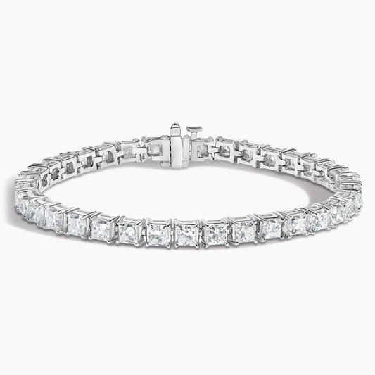 Princess cut diamond tennis bracelet in white gold set against a white background