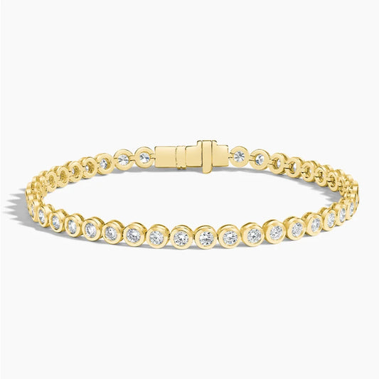 Yellow gold tennis bracelet with round lab-grown diamonds on white background