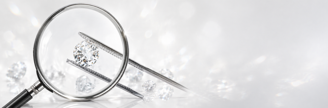 Round brilliant diamond held by tweezers under magnifying glass showing diamond inspection and grading