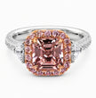 A luxury ring featuring a large cushion-cut pink molybdenite center stone in a rose gold halo, set on a silver-colored band with pavé diamonds and round diamonds, shot against a clean white background.