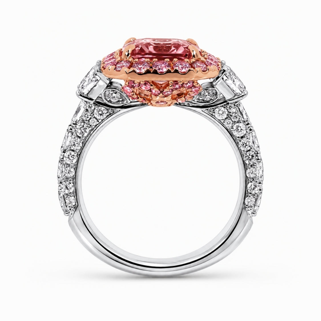 A high-end diamond and gemstone ring featuring a large cushion-cut pink center stone surrounded by smaller pink stones, set in a rose gold halo on a silver-toned band paved with clear diamonds, shown on a white background.