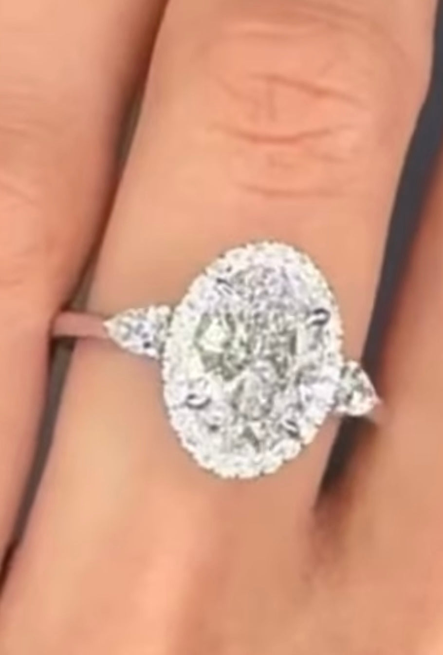 2 carat oval VS1 F lab diamond IGI certified with halo and 2x0.1 carat pear trilogy. Gold18karat