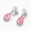 A pair of drop earrings featuring large pear-shaped pink diamonds set in silver-toned metal, with smaller round and marquise-cut clear diamonds above, photographed on a clean white background.