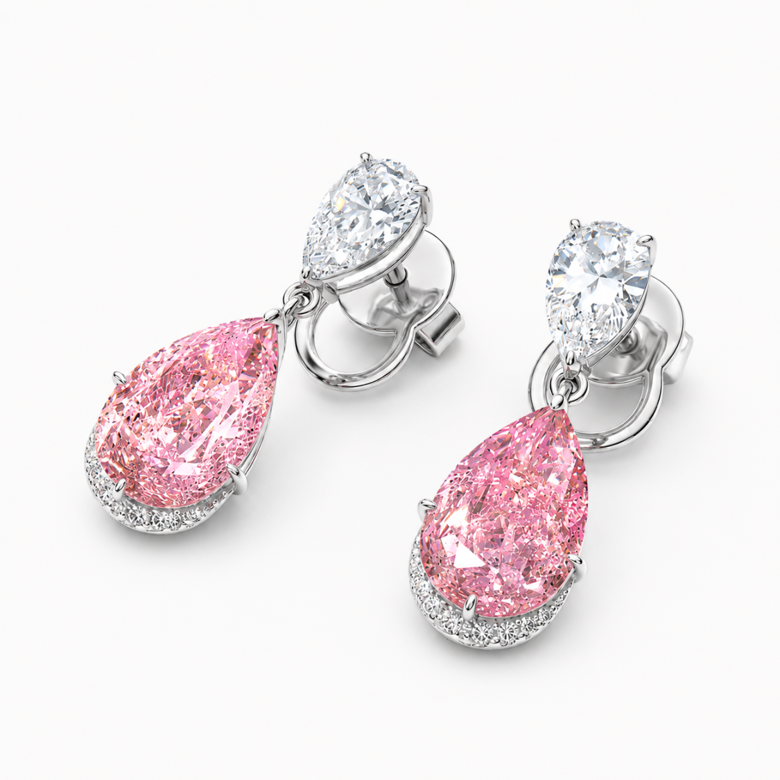 A pair of drop earrings featuring large pear-shaped pink diamonds set in silver-toned metal, with smaller round and marquise-cut clear diamonds above, photographed on a clean white background.