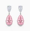 A pair of drop earrings featuring large pear-shaped pink diamonds set in silver-toned metal, with smaller round diamonds above in pear-cut shapes, shown on a light gray background.