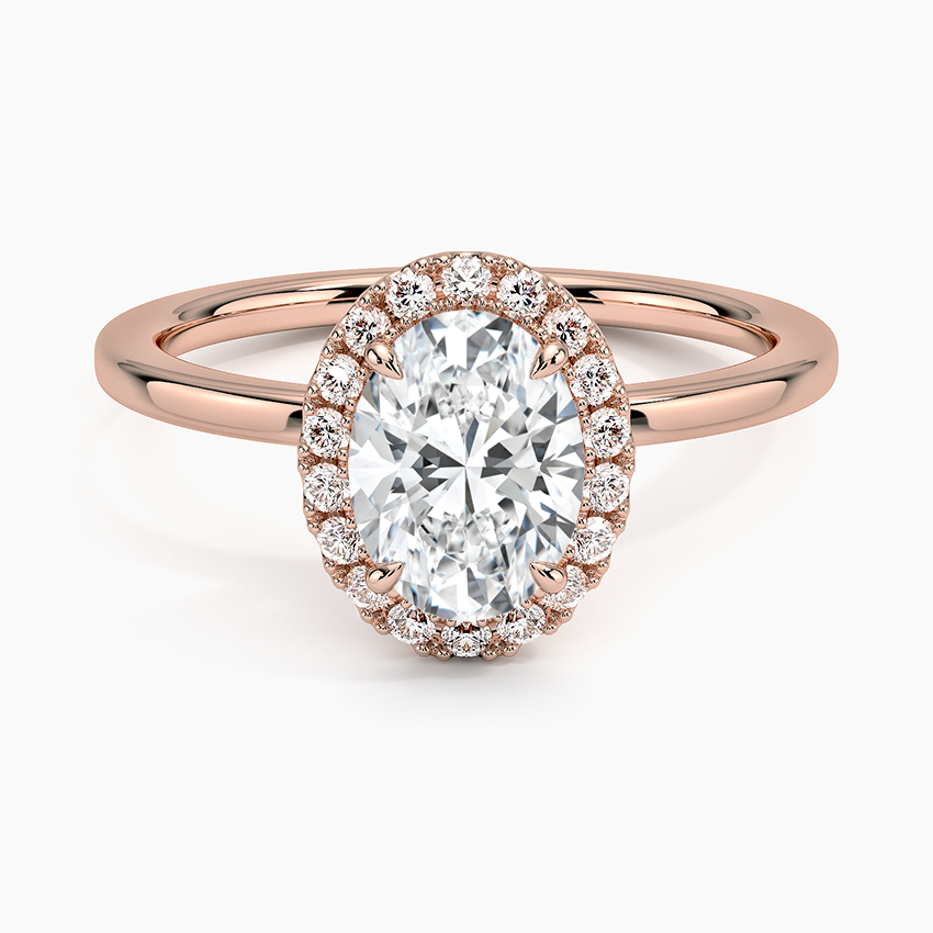 Oval halo diamond engagement ring with rose gold band and pavé accent stones