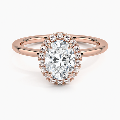 Oval halo diamond engagement ring with rose gold band and pavé accent stones