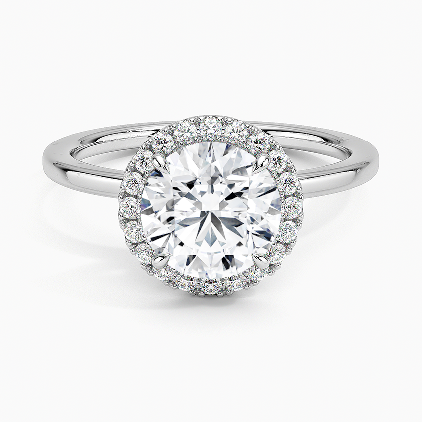 Round halo platinum engagement ring with large center diamond and pavé setting