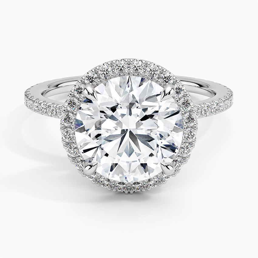 Platinum round halo engagement ring with pavé diamonds and large center stone