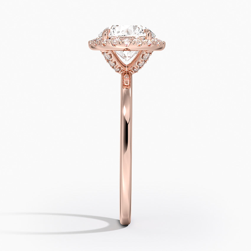 Rose gold engagement ring with round lab-grown diamond and halo setting, side view