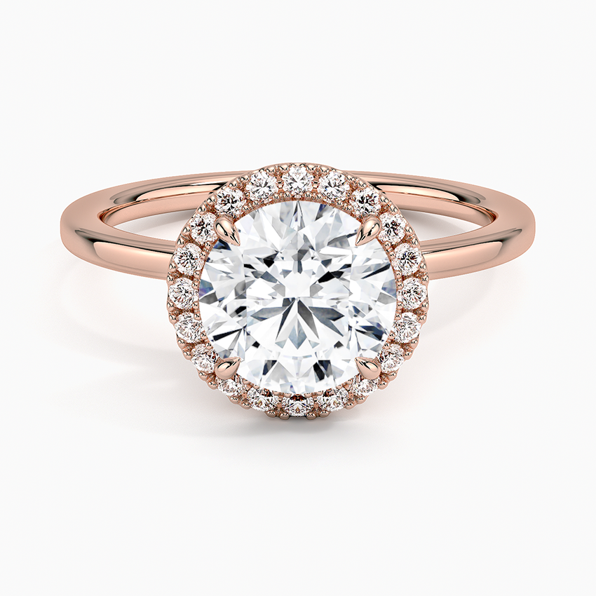 Rose gold halo engagement ring with round center lab-grown diamond and diamond accents
