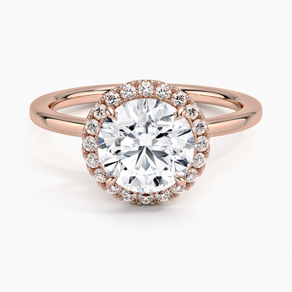 Rose gold halo engagement ring with round center lab-grown diamond and diamond accents