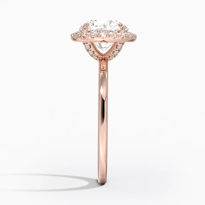 Side view of rose gold halo engagement ring with round lab-grown diamond and pavé setting