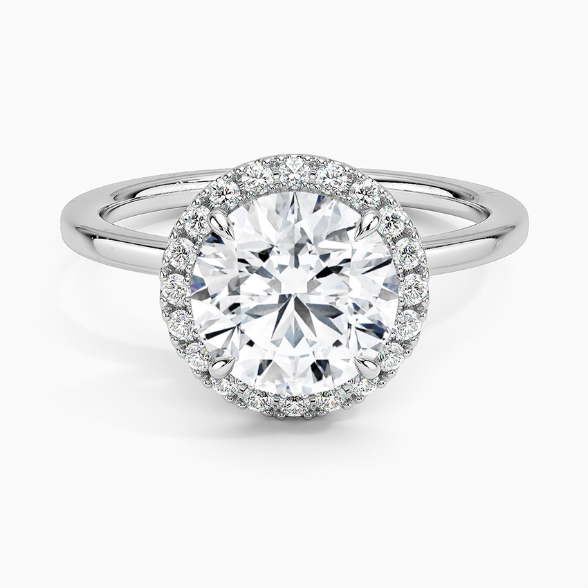 Round halo engagement ring with white lab-grown diamond center and pavé diamond accents