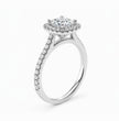 A silver-toned halo ring featuring a round-cut center stone surrounded by a double halo of smaller stones, with a pavé-set shank, shown on a clean white background.