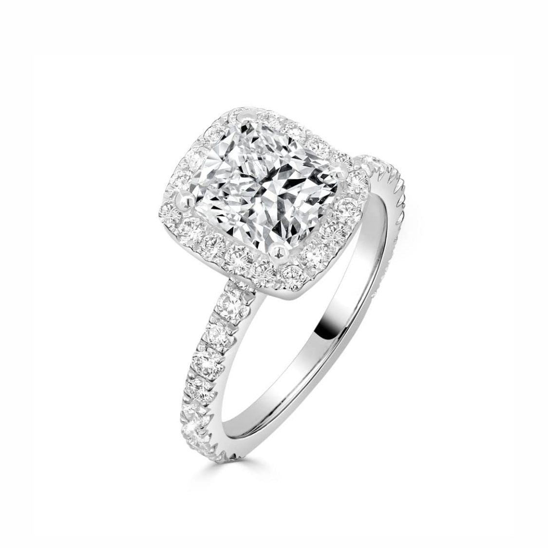 A cushion-cut diamond halo ring in white gold or platinum, featuring a large central diamond surrounded by a halo and a pavé-set band, shown on a clean white background.