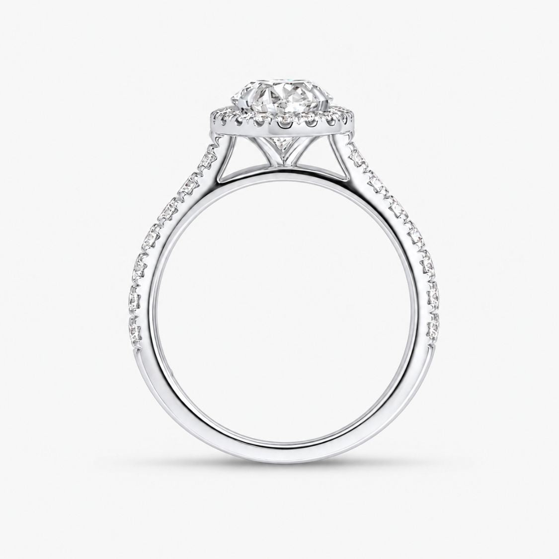 A silver diamond engagement ring with a round-cut center stone and a halo of smaller diamonds, set against a plain white background.
