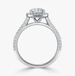 A silver-toned diamond engagement ring with a round-cut center stone and a halo of smaller diamonds, set against a clean white background.