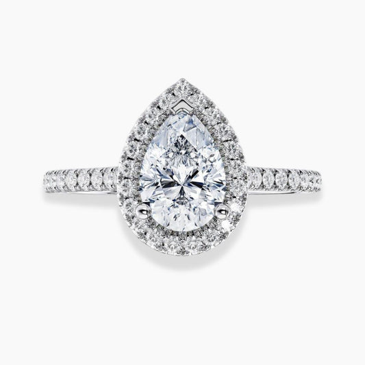 A pear-cut halo ring featuring a large clear pear-cut center stone surrounded by a halo of smaller round stones, with a pavé-set band, shown on a light gray background.