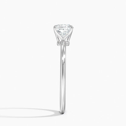 Side view of a platinum solitaire engagement ring with a cushion-cut diamond in a four-prong setting