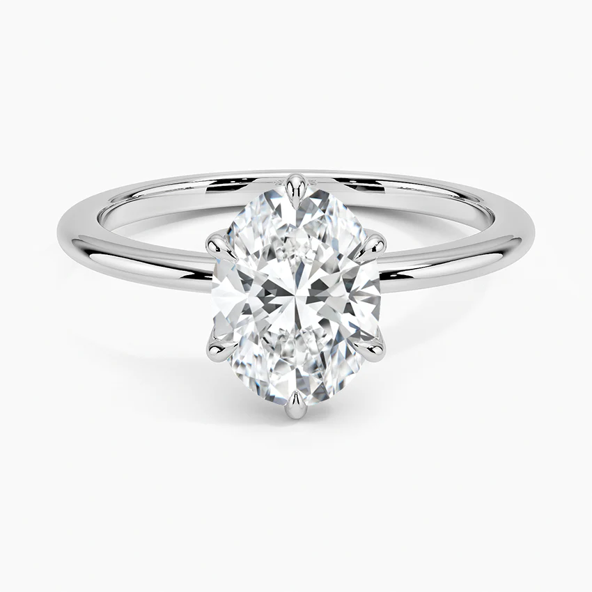 Solitaire oval lab-grown diamond engagement ring with white gold band on white background