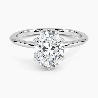 Oval-cut solitaire diamond engagement ring with white gold band on white background