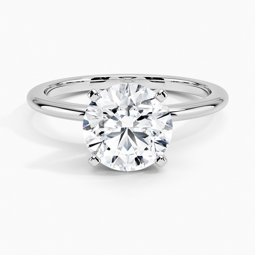 Round solitaire lab-grown diamond engagement ring with four-prong white gold setting