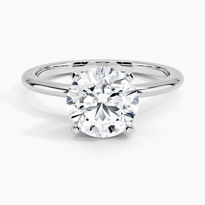 Round solitaire lab-grown diamond engagement ring in a classic four-prong white gold setting