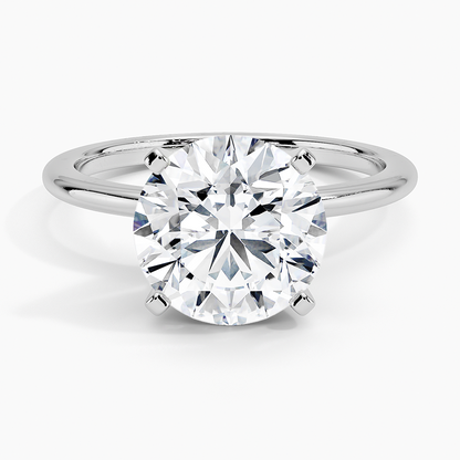 Round solitaire lab-grown diamond engagement ring in white gold with four prong setting