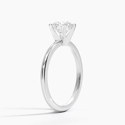 White gold solitaire engagement ring with round lab-grown diamond in four-prong setting